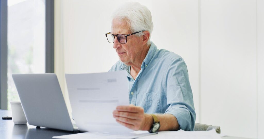 401k business funding - Documents laptop and research with old man in home for retirement fund asset man